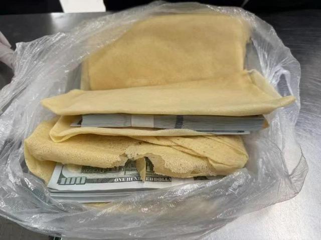 藏私房钱的招术用在这？海关在两名旅客行李中发现违规携带33万美元（五千美金）